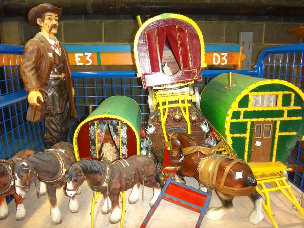 A group of four 20th century painted wooden models of Romany horse drawn caravans, together with four ceramic and resin horses and a resin figure of a