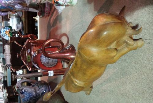 A group of collectables, including, two hunting horns, a copper kettle, a stirrup design desk barometer and a Continental carved wooden model of a bul