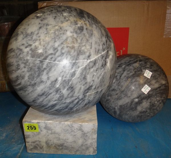 A large spherical marble ball on stand, together with another smaller.