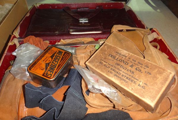 A quantity of leather maker's tools and offcuts contained in a brown case.