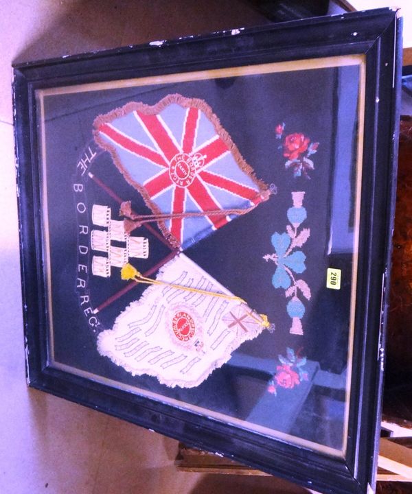 A framed and glazed embroidered panel depicting the arms and flags of The Border Regiment, in ebonised frame. Embroidery 73 by 60.5cmss