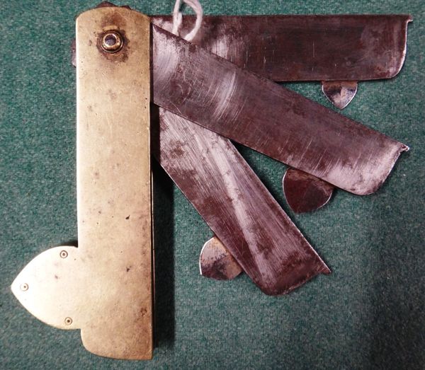 A Victorian steel and brass fleam, with three folding blades marked "Stockburn", 9.5cms wide