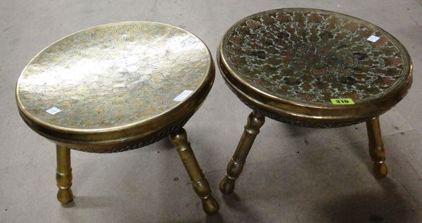 A pair of Middle Eastern brass and enamel decorated three legged stools, each with concave dished seat with profuse floral decoration above imbricated