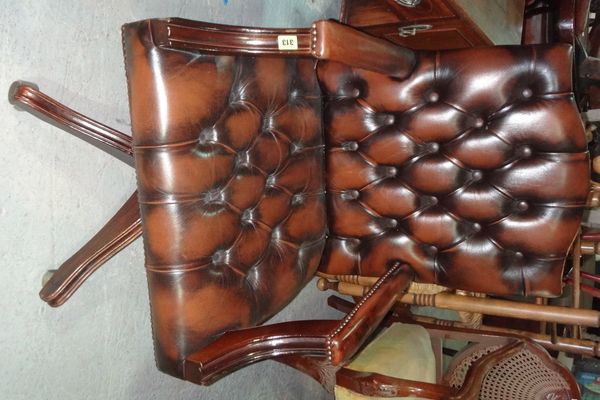 A brown leather button back office swivel chair.