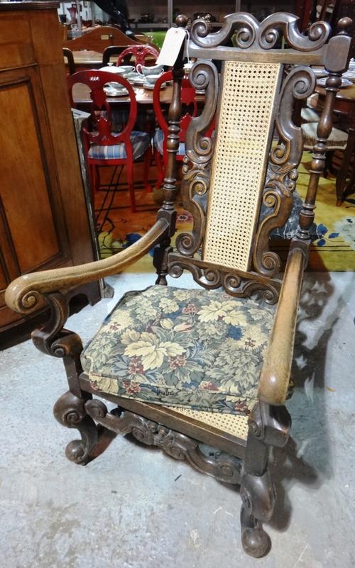A 17th century style oak famed open armchair.
