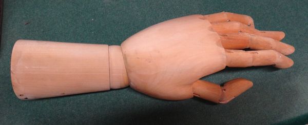 An artist's articulated softwood model of a hand and wrist, 31cms long.