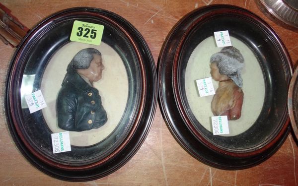 A pair of 19th century carved wax figural busts of a male and female.