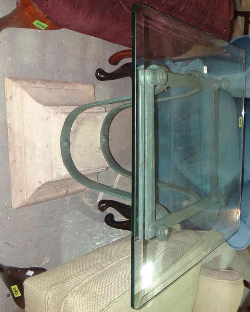 A wrought iron, stone and glass square occasional table.