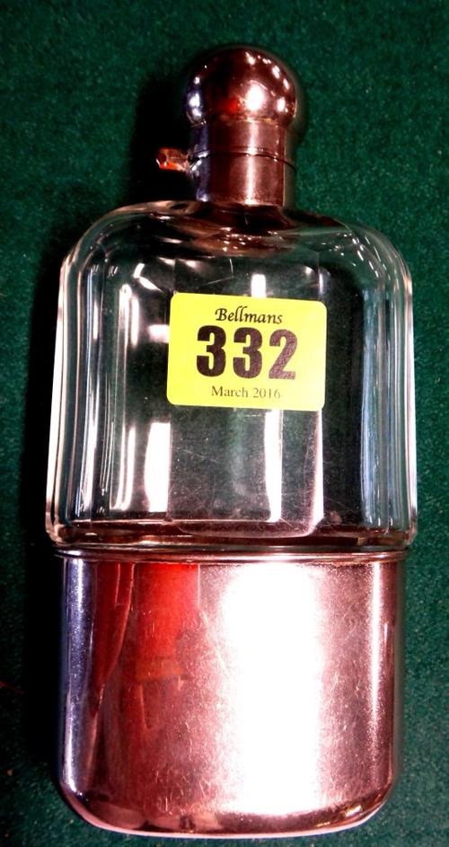 A silver plate mounted glass hipflask, domed hinged lid above facetted body and pull off sleeve base with gilded interior, 16.5cms high