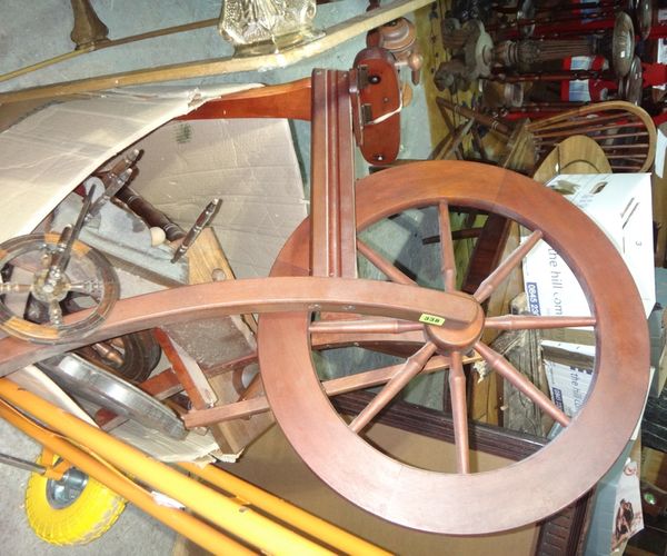 A 20th century hardwood spinning wheel.