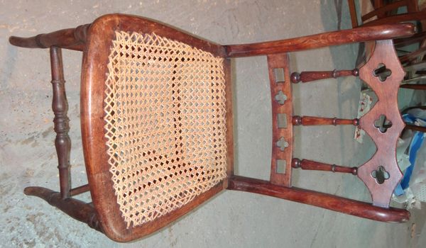 A set of five cane seated dining chairs.