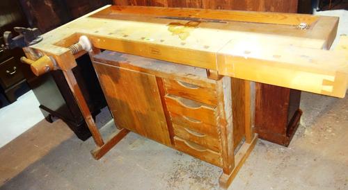 A wooden work bench by Linbergs, Sweden, with three adjustable vices, an undertier cupboard and five drawers, 140cm wide.