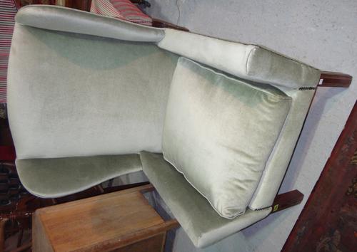 A George III style wing armchair and a red velvet upholstered Victorian nursing chair. (2)