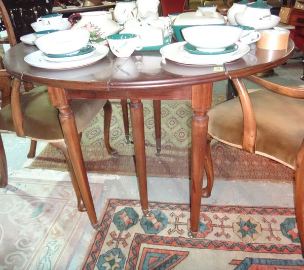 A French drop flap extending dining table, to include two extra leaves.
