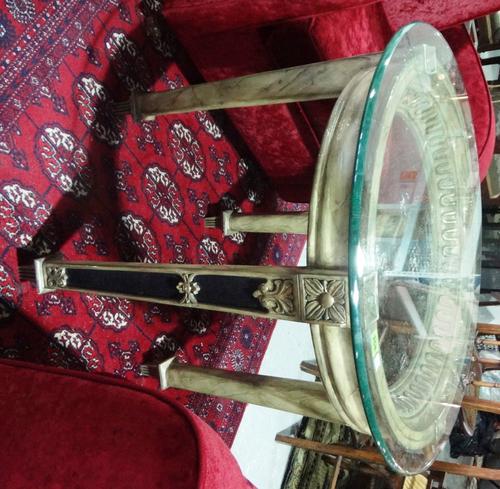 A 19th century gilt gesso circular occasional table with a circular glass top.