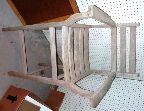 A tall teak armchair and a low teak chair fitted with a metal bowl. (2)