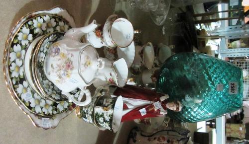 A hardwood and brass inlaid lift top chest with carved decoration and three drawers.
