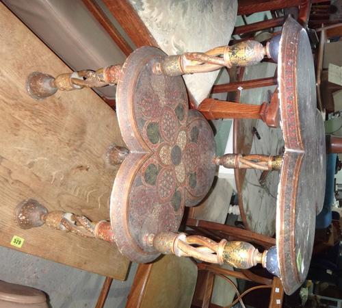 A 19th century Indian polychrome painted two tier trefoil shaped occasional table and an inlaid brass tray. (2)