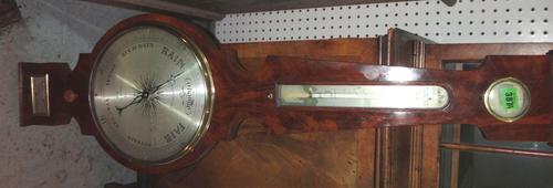 An early 19th century mahogany wheel barometer by A. Martinelli 43 Union St, Boro, together with an Austrian wall clock with pendulum and key.