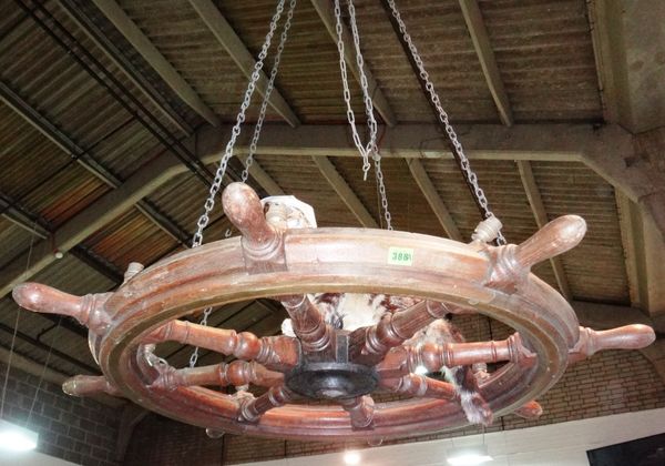 A large ship's wheel, converted to a hanging light.