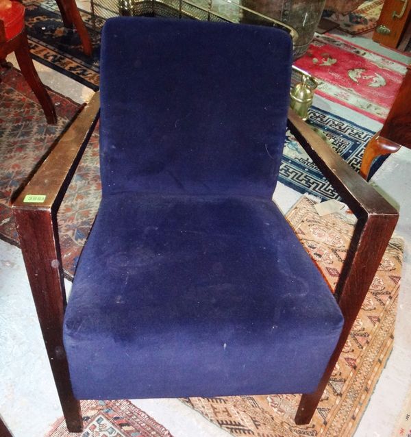 A pair of 20th century ebonised low armchairs with blue velvet upholstery.
