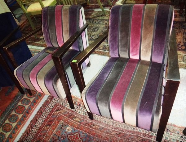 A pair of 20th century ebonised low armchairs with striped velvet upholstery.