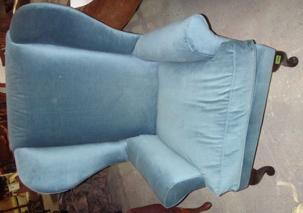 A 20th century blue upholstered wing armchair.