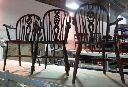 Three similar spindle back open armchairs.