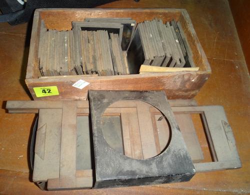 A quantity of magic lantern slides and elements of a lantern.