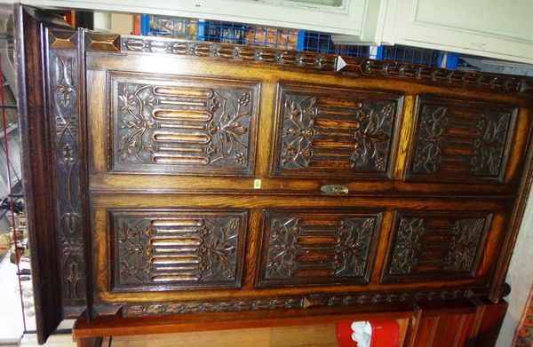 A 20th century oak wardrobe with carved panel decoration.