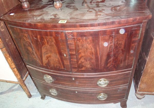 A 19th century mahogany commode with pair of cupboards and drawers.