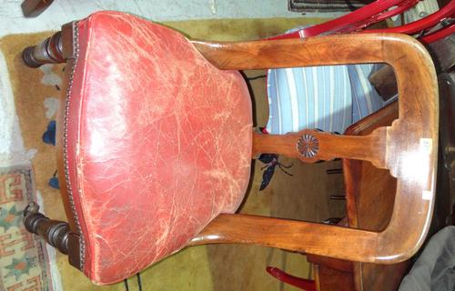 A set of eight Victorian walnut and mahogany buckle back dining/office chairs.