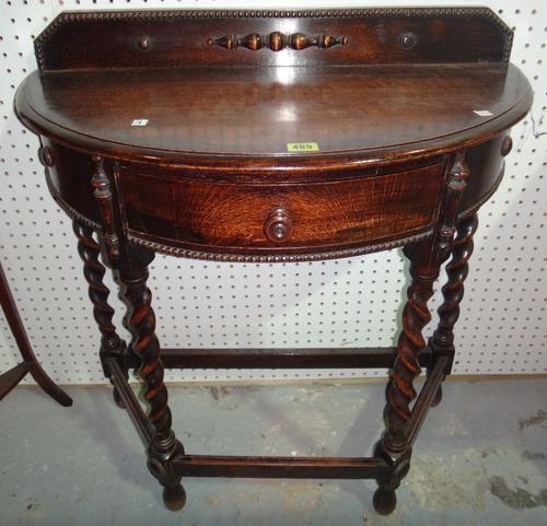 An oak demi-lune hall table and an oak bedside cupboard. (2)
