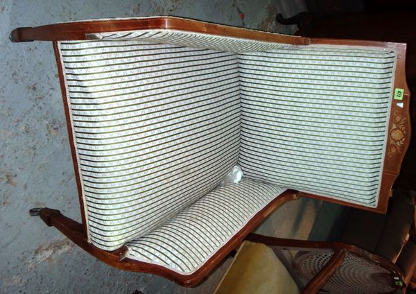 An Edwardian mahogany framed upholstered armchair.