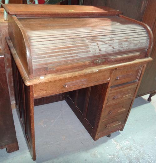 An early 20th century oak roll top desk.