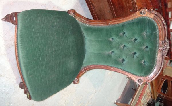 A Victorian carved walnut nursing chair with green button upholstery.