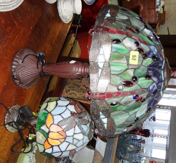 A 'Tiffany' style metal table lamp with leaded and coloured shade, together with another similar. (2)