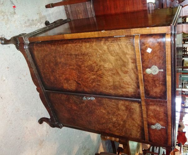 A 20th century walnut side cabinet with a pair of drawers and cupboards.