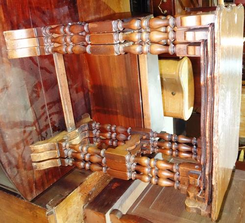 A nest of three walnut tables and a mahogany swing frame mirror.