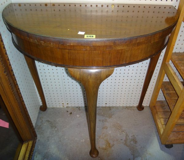 A 20th century mahogany foldover tea table.
