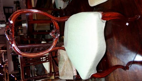 A set of three 19th century walnut balloon back chairs.