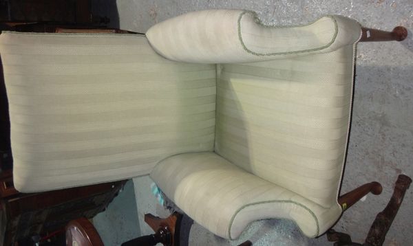 A 19th century mahogany upholstered armchair with square back and pad feet.
