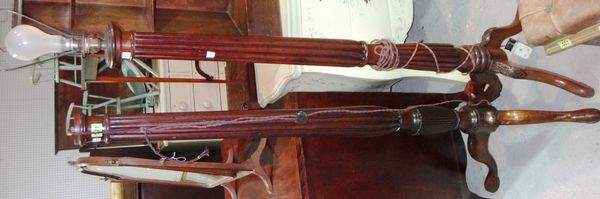 A carved mahogany standard lamp with reeded column and another similar.