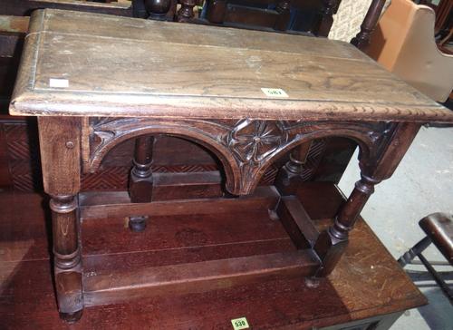 A pair of oak single sided drop flap occasional tables, with Gothic arch decoration.