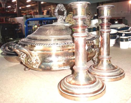 A group of silver plated items, including entree dishes, candlesticks and flatware.