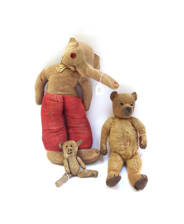 A vintage teddy bear with golden fur, hand stitched snout and jointed limbs, 37cm high, and two further stuffed toy animals (a.f). (3)