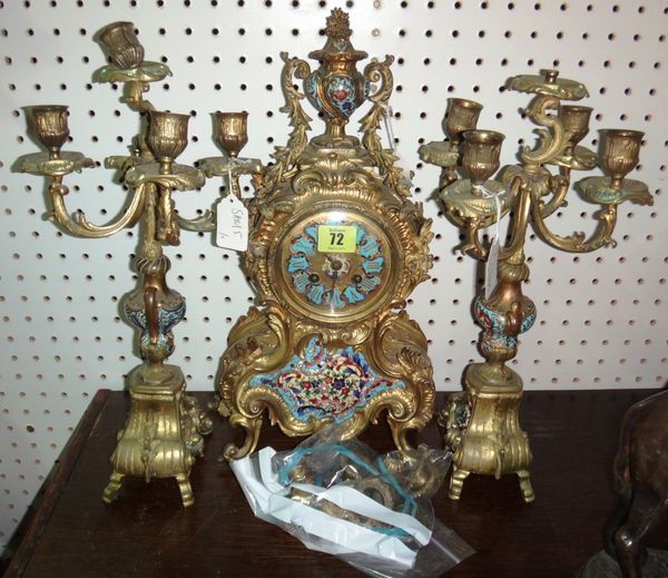 A 19th century gilt metal and enamel decorated eight day mantel clock, together with a pair of five branch candelabra.