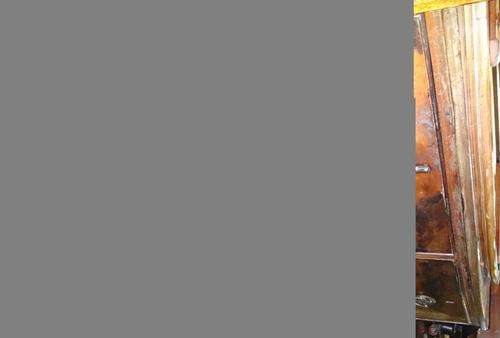 A Black Forest carved wooden cuckoo clock, early 20th century, with apex roof over a mechanised cuckoo aperture, the dial surrounded with carved fruit