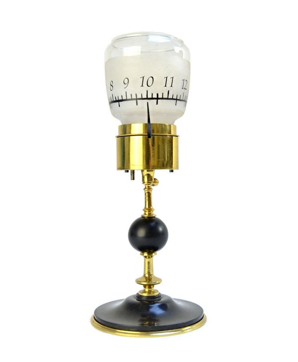 A French gilt and patinated brass table clock of candlestick form, early 20th century, the frosted cylindrical shade detailed with numerals over a sin