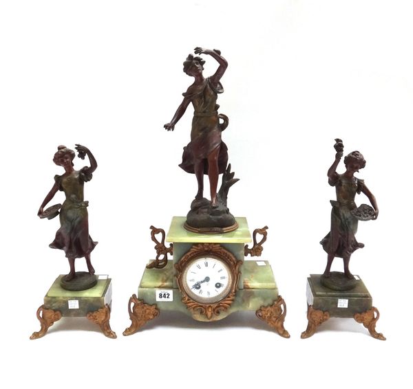 A onyx and spelter mounted figural clock garniture, early 20th century, the patinated spelter figurine titled 'Brise Bete' over a gilt brass embellish